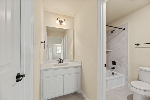 full bathroom featuring tile patterned flooring, vanity, tiled shower / bath combo, and toilet