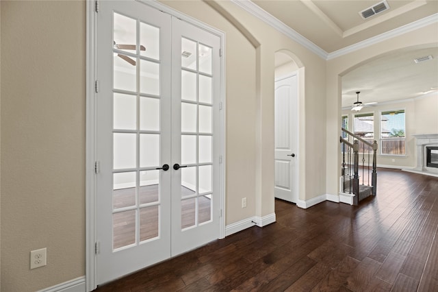 doorway with ornamental molding, french doors, dark wood-type flooring, and ceiling fan