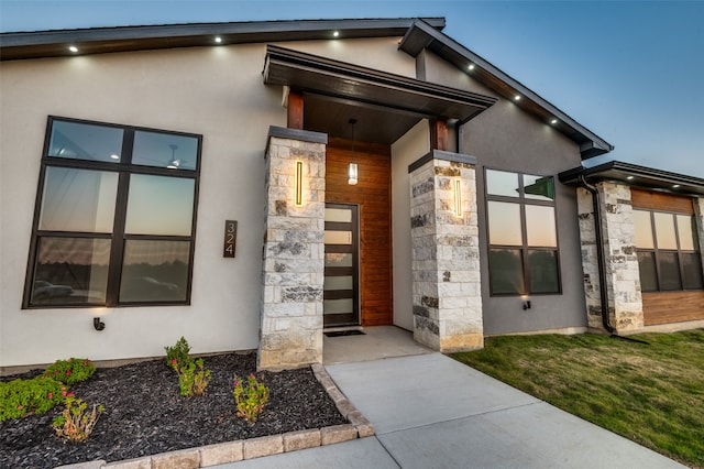 exterior entry at dusk with a lawn