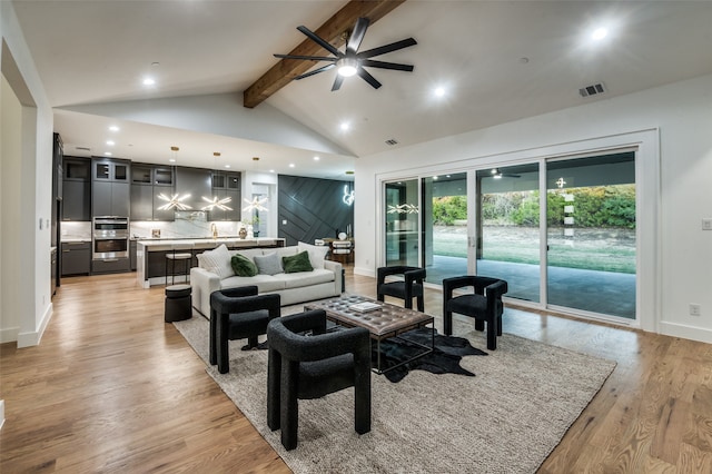 living room with light wood-type flooring, vaulted ceiling with beams, and ceiling fan