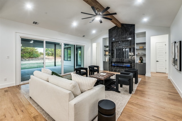 living room featuring vaulted ceiling with beams, ceiling fan, and light hardwood / wood-style flooring