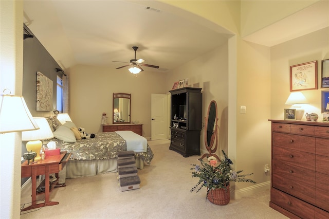 carpeted bedroom with ceiling fan and vaulted ceiling