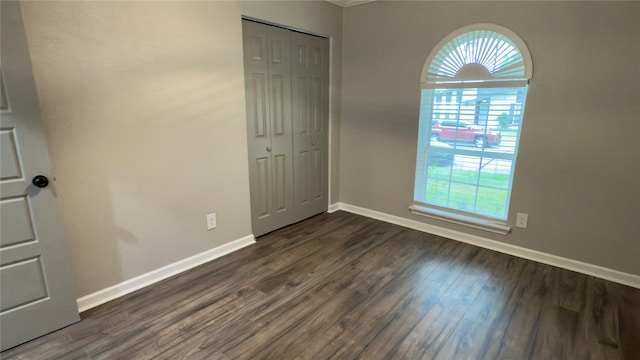 unfurnished room featuring dark hardwood / wood-style flooring