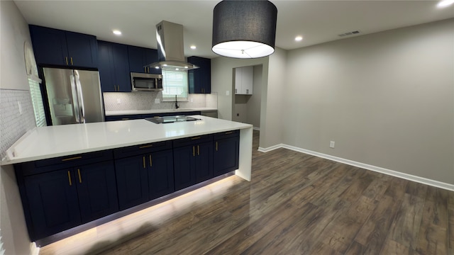 kitchen featuring stainless steel appliances, tasteful backsplash, island range hood, blue cabinetry, and dark wood-type flooring