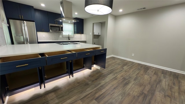 kitchen with blue cabinetry, appliances with stainless steel finishes, island exhaust hood, and dark hardwood / wood-style flooring