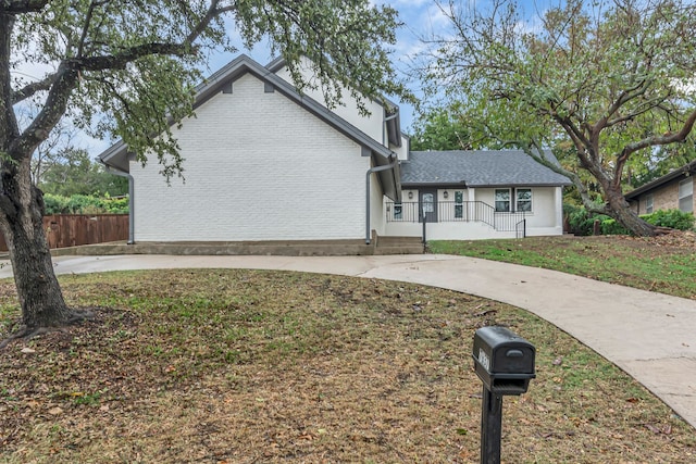 view of front of home with covered porch and a front yard