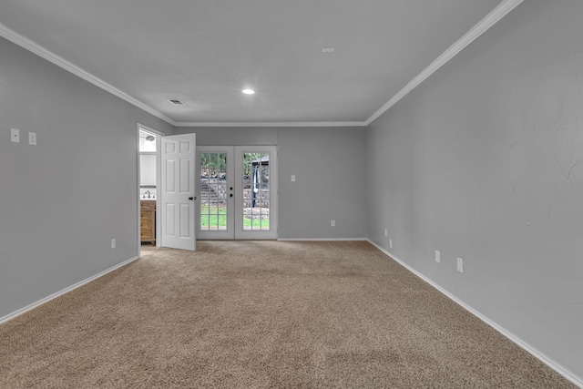 carpeted spare room featuring french doors and crown molding