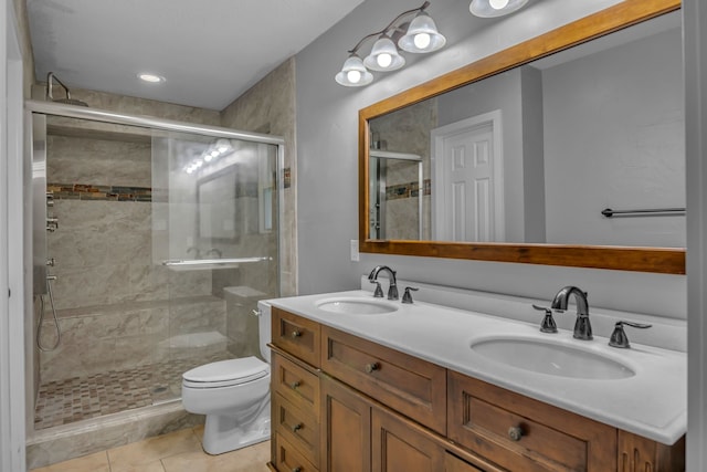 bathroom featuring tile patterned flooring, vanity, toilet, and a shower with shower door