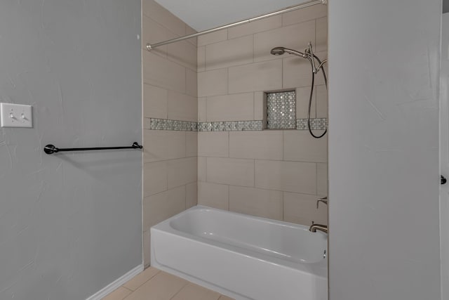 bathroom featuring tiled shower / bath and tile patterned flooring