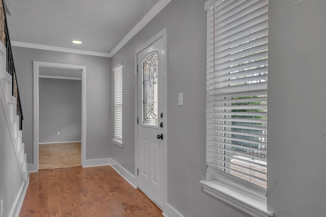 foyer featuring wood-type flooring and ornamental molding