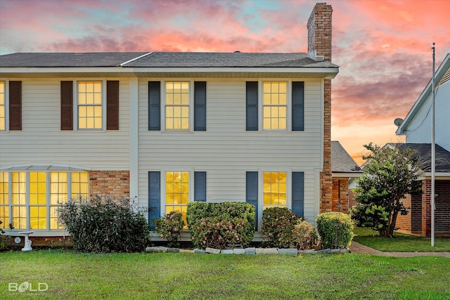 colonial-style house with a lawn