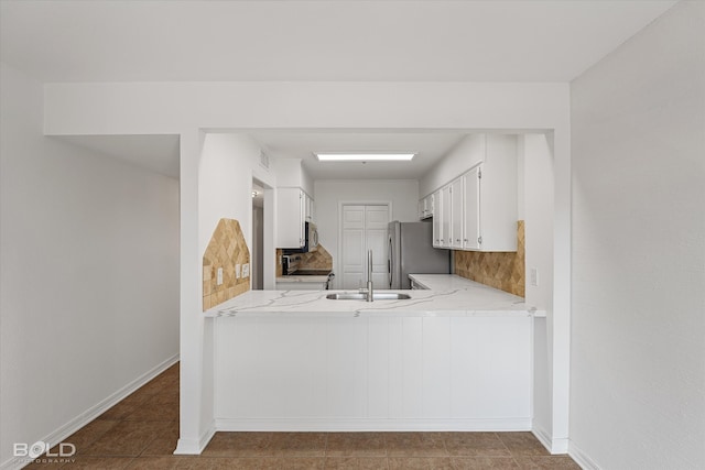 kitchen featuring white cabinetry, tile patterned floors, light stone countertops, and stainless steel appliances