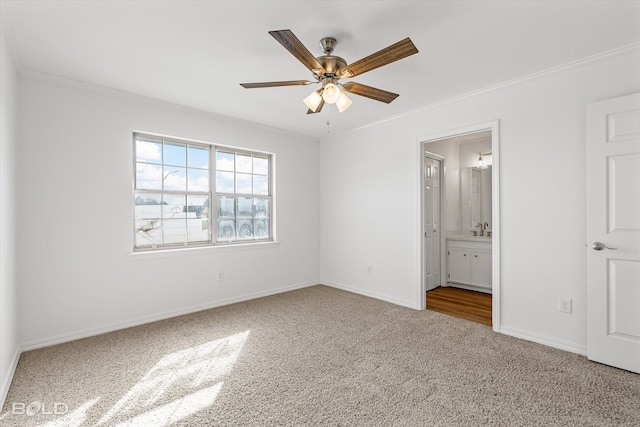 unfurnished bedroom with ensuite bath, carpet floors, and ceiling fan