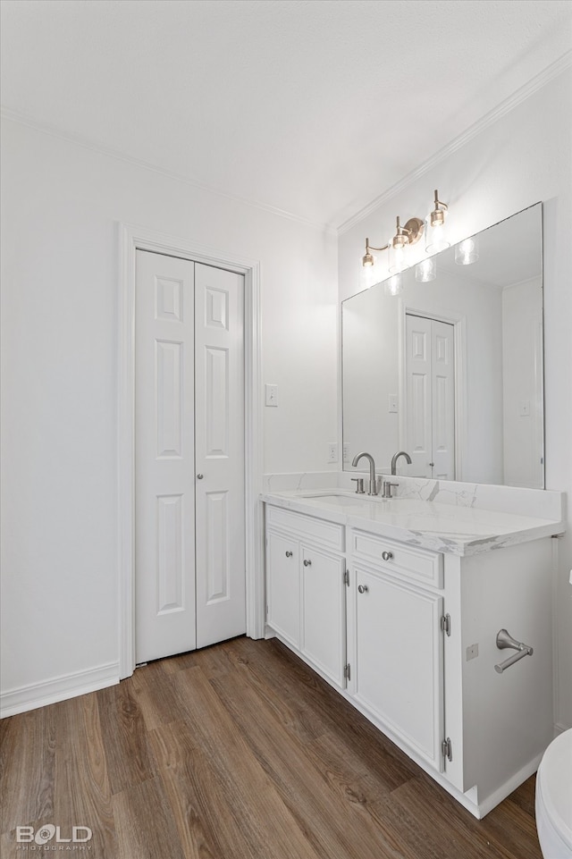 bathroom with hardwood / wood-style floors, vanity, and toilet