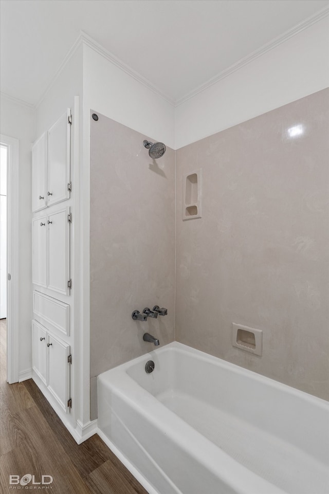 bathroom featuring tiled shower / bath combo, hardwood / wood-style flooring, and crown molding