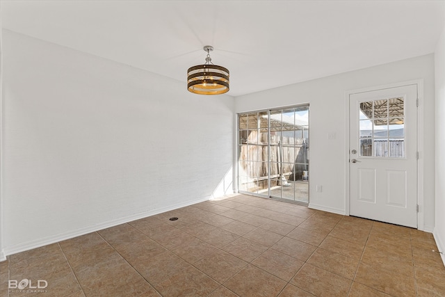 interior space featuring an inviting chandelier and light tile patterned floors