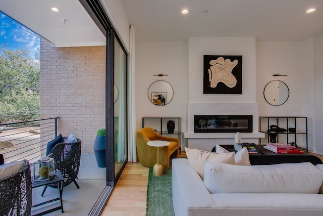 living room with brick wall and light wood-type flooring