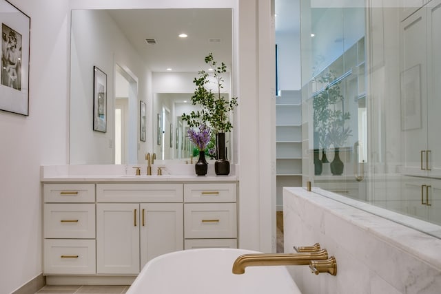 bathroom with vanity, tile patterned floors, and separate shower and tub