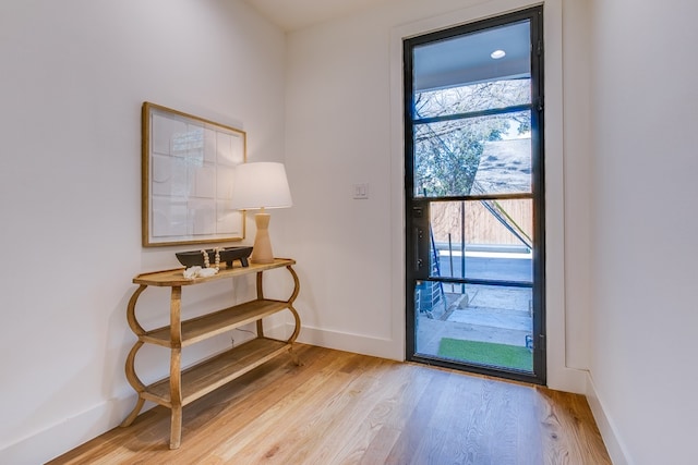 doorway with light hardwood / wood-style flooring