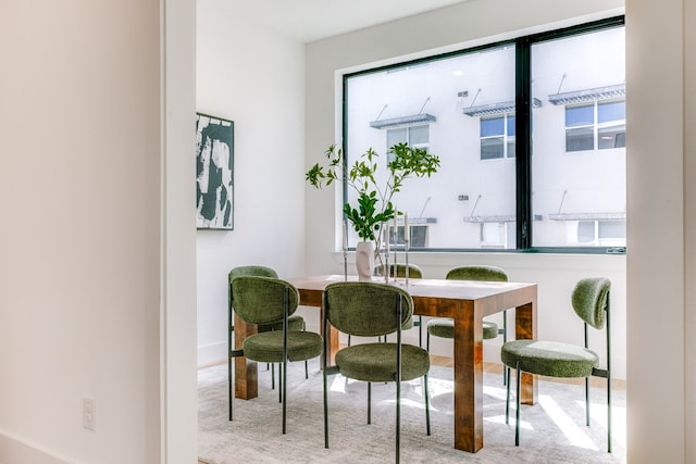 dining space featuring light colored carpet