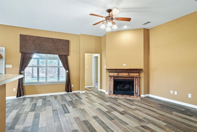 unfurnished living room featuring wood-type flooring and ceiling fan