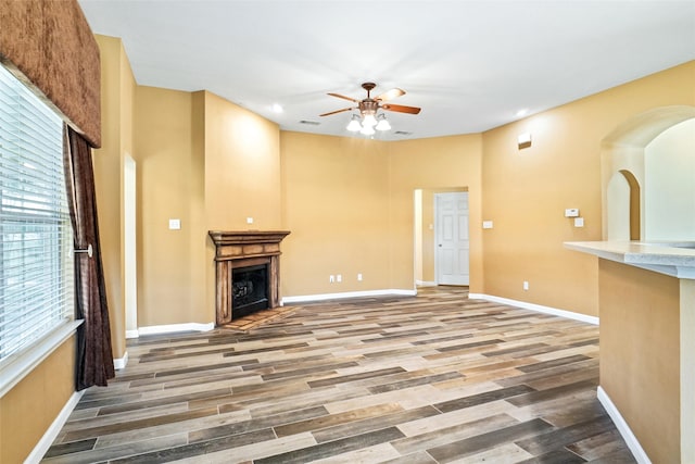 unfurnished living room with hardwood / wood-style floors and ceiling fan