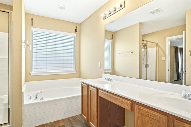 bathroom featuring vanity, hardwood / wood-style flooring, and separate shower and tub