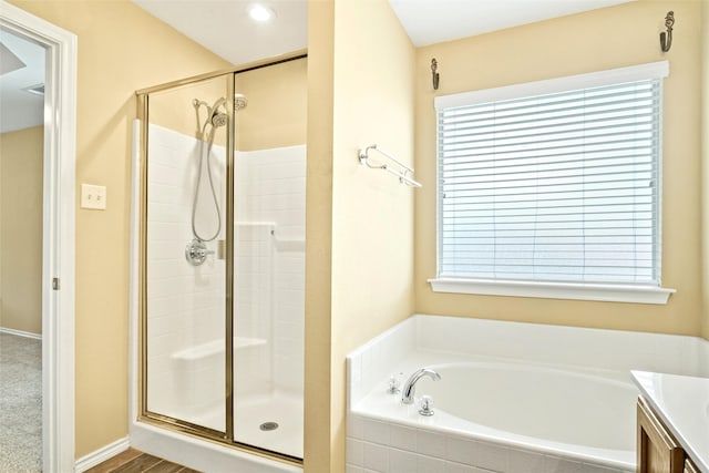 bathroom featuring plenty of natural light, vanity, and independent shower and bath