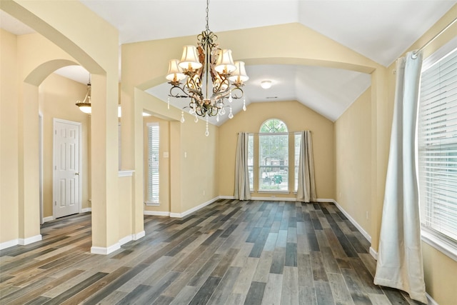 foyer featuring dark hardwood / wood-style flooring, a chandelier, and vaulted ceiling