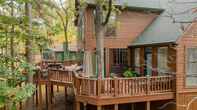 rear view of house featuring a wooden deck