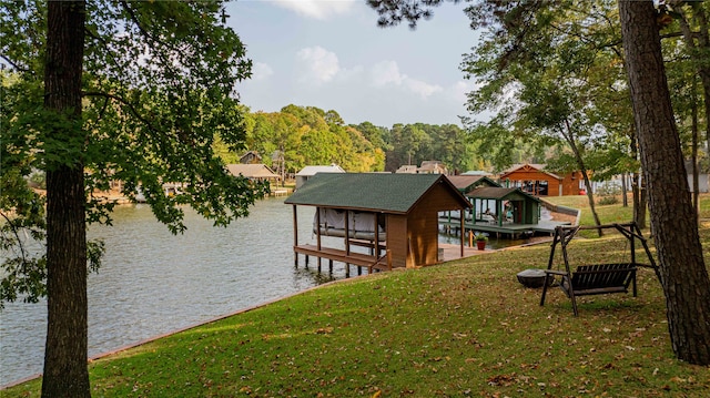 view of dock with a yard and a water view