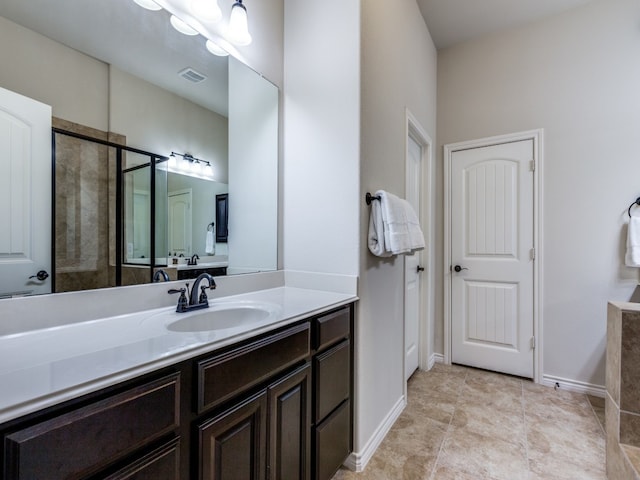 bathroom featuring vanity, tile patterned floors, and a shower with shower door