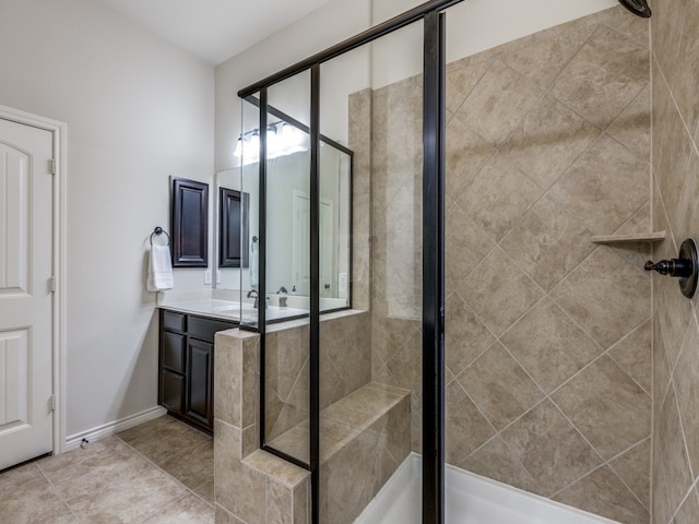 bathroom featuring walk in shower, vanity, and tile patterned flooring