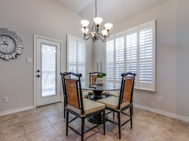 dining area featuring an inviting chandelier, vaulted ceiling, and light tile patterned flooring