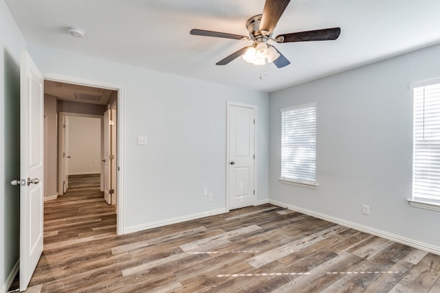 empty room with wood-type flooring and ceiling fan