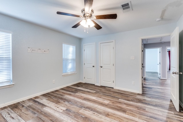 unfurnished bedroom featuring light hardwood / wood-style floors and ceiling fan