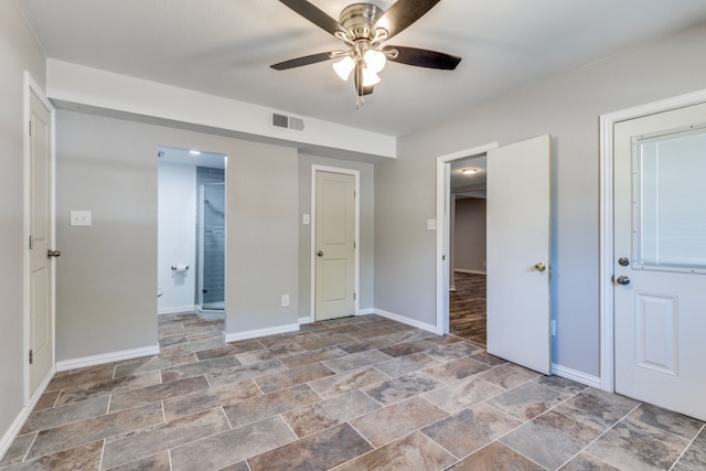 unfurnished bedroom with ceiling fan and ensuite bathroom