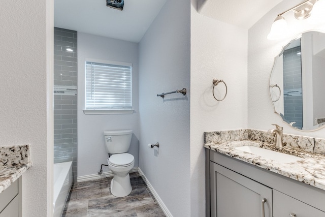 full bathroom featuring toilet, vanity, and tiled shower / bath