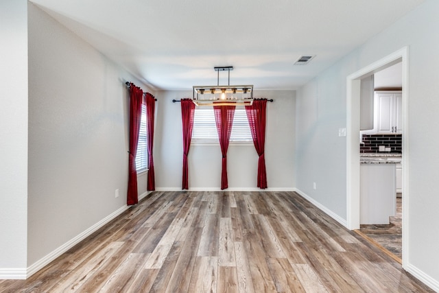 unfurnished dining area with light hardwood / wood-style floors