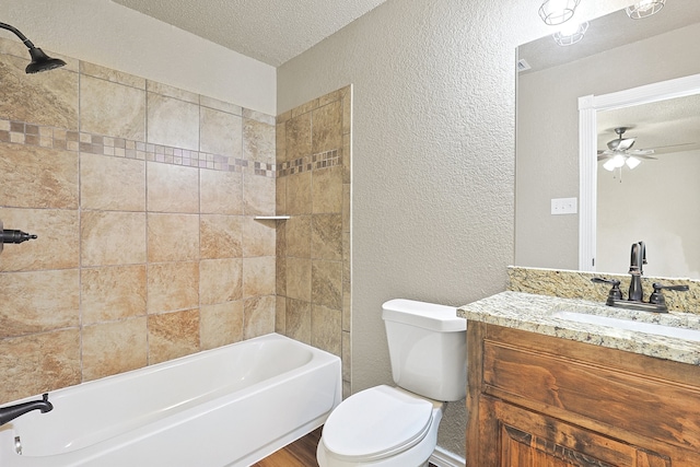 full bath with a textured wall, toilet, tub / shower combination, a textured ceiling, and vanity