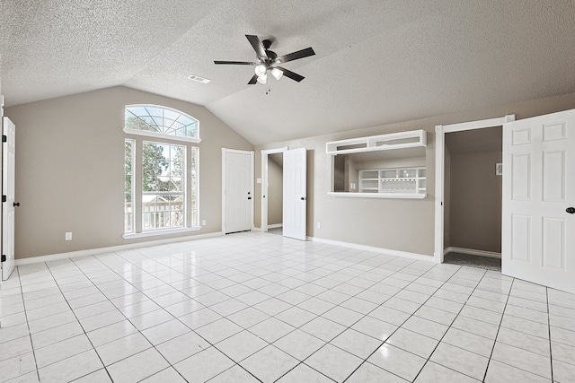 unfurnished living room with light tile patterned floors, ceiling fan, lofted ceiling, and visible vents