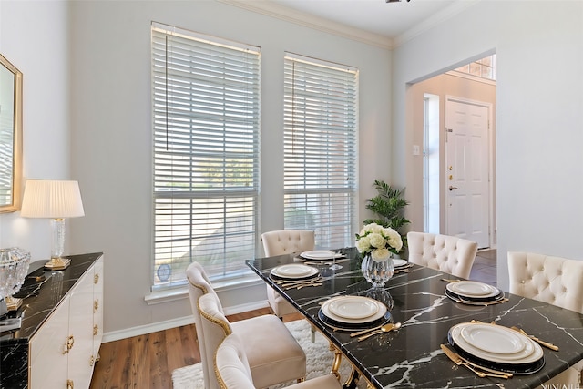 dining room with wood-type flooring and ornamental molding