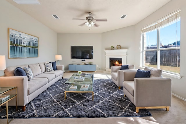 carpeted living room featuring ceiling fan and a healthy amount of sunlight