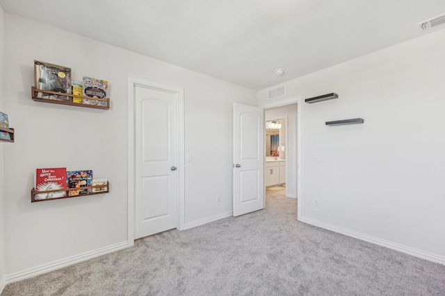 unfurnished bedroom featuring light colored carpet