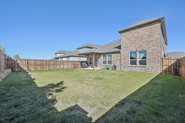 rear view of property featuring a patio area and a lawn