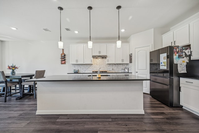 kitchen with white cabinetry, decorative light fixtures, and dark hardwood / wood-style flooring