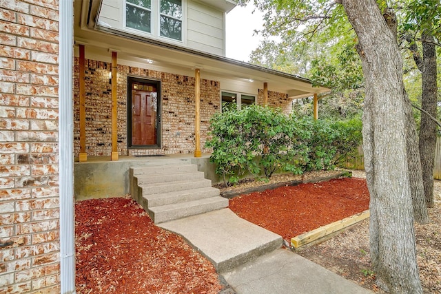 view of exterior entry with a porch