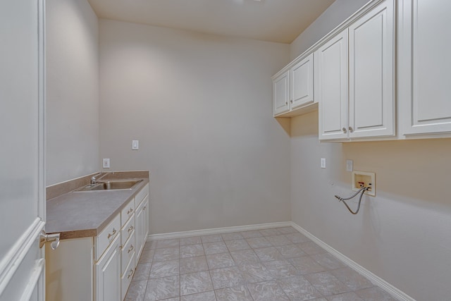 laundry room with cabinets, washer hookup, and sink