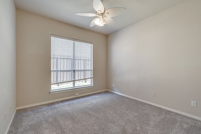 carpeted empty room featuring ceiling fan and plenty of natural light