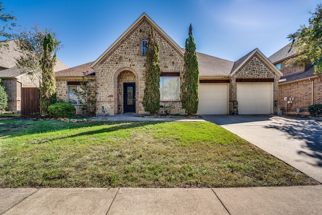 view of front facade with a garage and a front yard